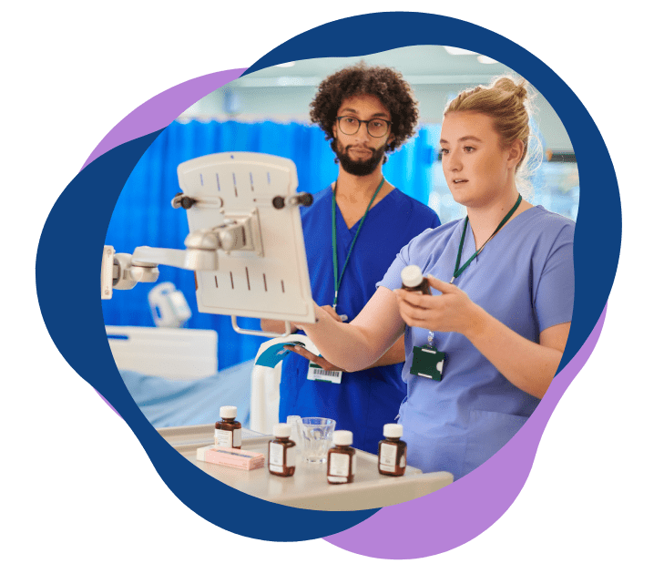 Two healthcare professionals reviewing medication information in a clinical setting.