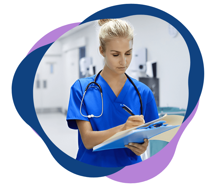 Female nurse writing on a clipboard in a hospital.