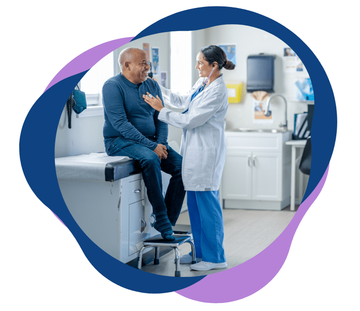 Doctor examining an elderly man in a medical office.