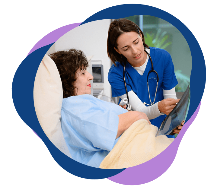 Doctor reviewing medical information with a patient in a hospital bed.
