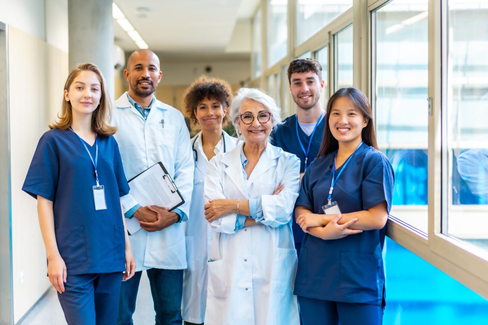 Diverse medical team standing confidently in a hospital corridor.
